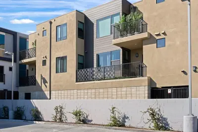 an apartment building with balconies on a street at Modern 2 Bedroom King Bed EVCharger Pet-Friendly Balcony in San Diego