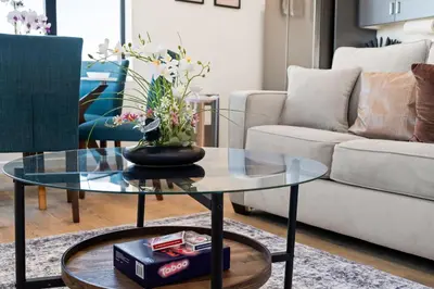 a living room with a glass table and a couch at Modern 2 Bedroom King Bed EVCharger Pet-Friendly Balcony in San Diego