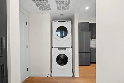 a laundry room with a washer and dryer in a kitchen at Stylish 2 Bedroom King Bed EVCharger Pet-Friendly Balcony in San Diego