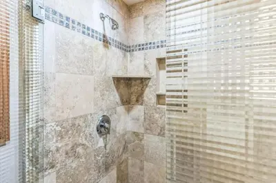 a bathroom with a shower with a glass door at Massive 3 bedroom on the sand-STR14-0133 in Dana Point