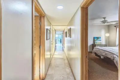 a hallway of a bedroom with a bed and a mirror at Massive 3 bedroom on the sand-STR14-0133 in Dana Point