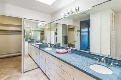 a bathroom with three sinks and two mirrors at Massive 3 bedroom on the sand-STR14-0133 in Dana Point