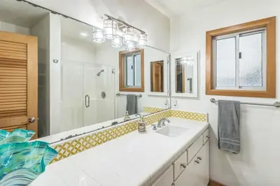 a bathroom with a sink and a large mirror at Massive 3 bedroom on the sand-STR14-0133 in Dana Point
