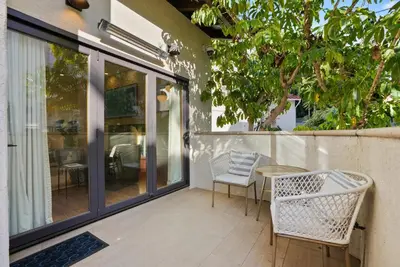 a patio with a table and chairs on a balcony at Village Vistas - Walk to Beach and LJ Village, AC, Spa in San Diego