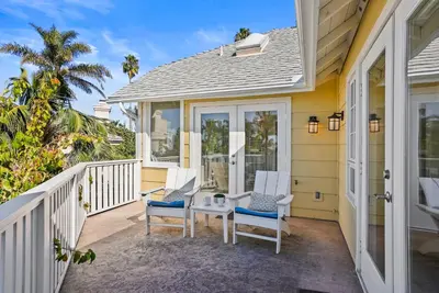 a porch with two chairs and a table at Lovely home with backyard oasis & great WiFi - walk to La Jolla Village, dogs OK in San Diego