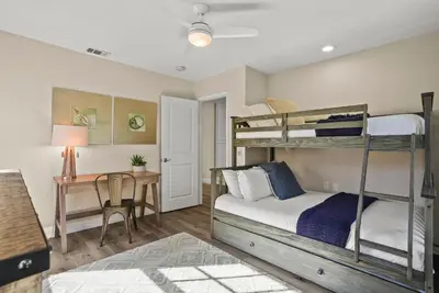 a bedroom with two bunk beds and a desk at Lovely home with backyard oasis & great WiFi - walk to La Jolla Village, dogs OK in San Diego
