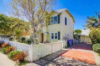 a white fence in front of a house at Lovely home with backyard oasis & great WiFi - walk to La Jolla Village, dogs OK in San Diego