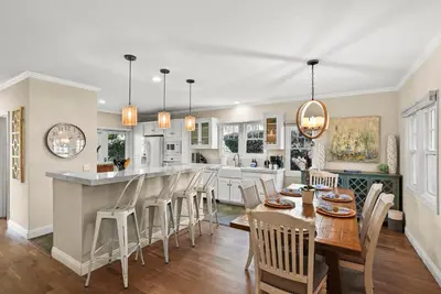 a kitchen and dining room with a table and chairs at Lovely home with backyard oasis & great WiFi - walk to La Jolla Village, dogs OK in San Diego