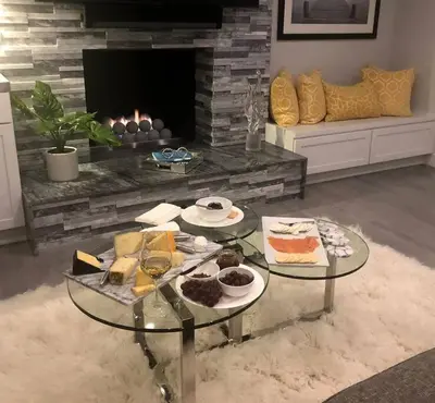 a living room with a table with food and a fireplace at Laguna Beach House in Laguna Beach
