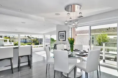 a dining room with a table and white chairs at Laguna Beach House in Laguna Beach