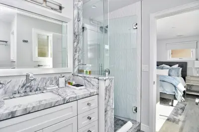 a bathroom with a sink and a shower and a bed at Laguna Beach House in Laguna Beach