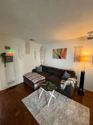 a living room with a couch and a table at Boho Chic Loft Little Italy Walk Everywhere in San Diego
