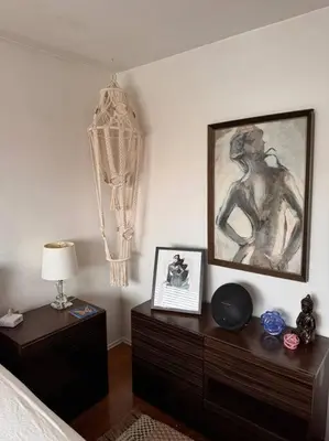 a bedroom with a bed and a dresser with a picture at Boho Chic Loft Little Italy Walk Everywhere in San Diego