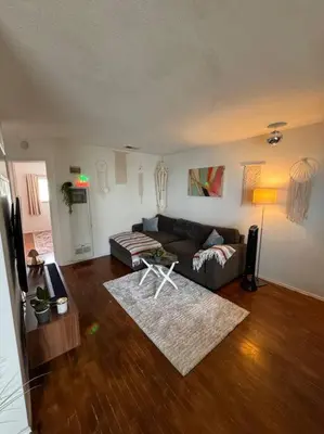 a living room with a couch and a table at Boho Chic Loft Little Italy Walk Everywhere in San Diego