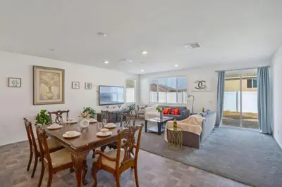 a dining room and living room with a table and chairs at Entire Private Home with 4 Bedrooms 2 Bathrooms, Mountain Edge, New House, Ranch, Gated Yard, Available Now in Menifee