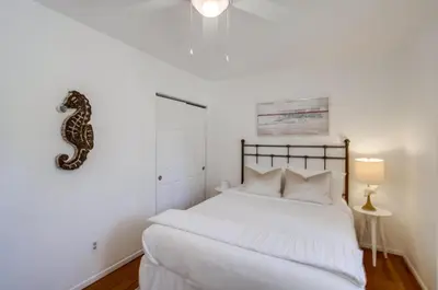 a bedroom with a bed with a snake on the wall at Tidal Wave 1 in San Diego