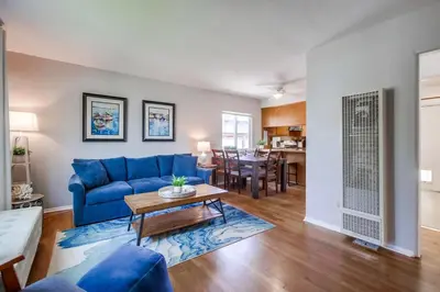 a living room with a blue couch and a table at Tidal Wave 1 in San Diego