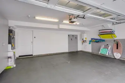 an empty garage with a surfboard on the wall at The Shores 7 in San Diego