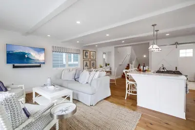 a living room with a white couch and a kitchen at The Shores 7 in San Diego