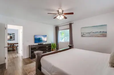 a bedroom with a bed and a ceiling fan at Tidal Wave 2 WINTER SPECIAL! in San Diego