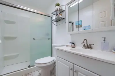 a bathroom with a toilet and a glass shower at Tidal Wave 2 WINTER SPECIAL! in San Diego