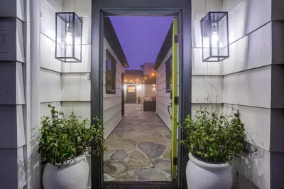 an open door with two potted plants in a hallway at Terramar Point in Carlsbad