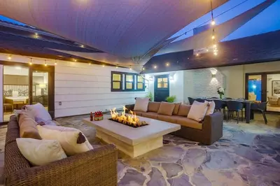 a living room with a couch and a fire pit at Terramar Point in Carlsbad