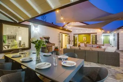 a dining table and chairs in a living room at Terramar Point in Carlsbad