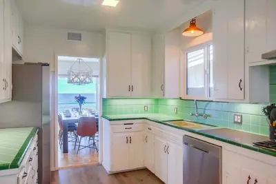 a kitchen with white cabinets and a view of the ocean at Terramar Point in Carlsbad