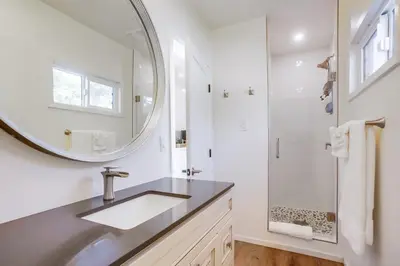 a bathroom with a sink and a mirror at Terramar Point in Carlsbad