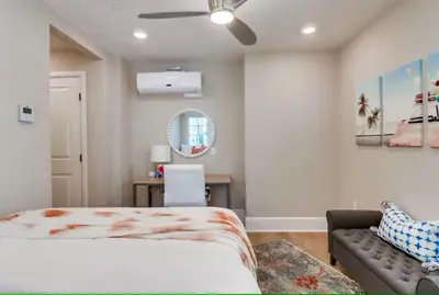 a bedroom with a bed and a couch and a mirror at Bayside Cove 7 in San Diego