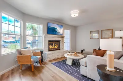 a living room with a couch and a fireplace at Local Gem 1 in San Diego