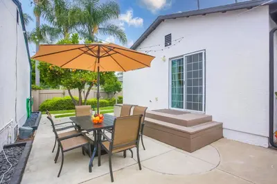a table and chairs with an umbrella on a patio at Pipeline in San Diego