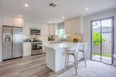 a kitchen with white cabinets and a white counter top at Pipeline in San Diego