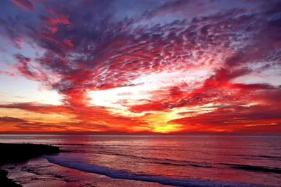 a sunset over the ocean with the sky at Pipeline in San Diego