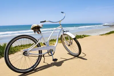 a bike parked on the beach near the ocean at Pipeline in San Diego