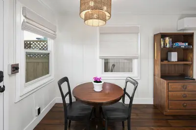 a dining room with a wooden table and chairs at Surf Cottage 1 in San Diego