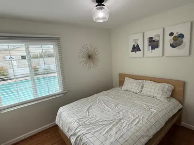 a bedroom with a bed and a window at Heated pool, Sunny San Diego, Entire home, Free Parking, BBQ, Pets allowed, family neighborhood! in San Diego
