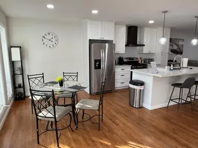 a kitchen with a table and chairs and a refrigerator at Heated pool, Sunny San Diego, Entire home, Free Parking, BBQ, Pets allowed, family neighborhood! in San Diego