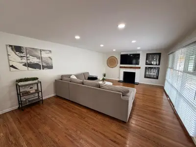 a living room with a couch and a fireplace at Heated pool, Sunny San Diego, Entire home, Free Parking, BBQ, Pets allowed, family neighborhood! in San Diego