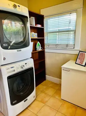 a kitchen with a washing machine and a microwave at 3-Bedroom, Prime Location, Private Backyard! in San Diego