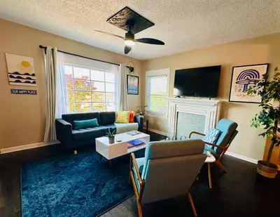 a living room with a couch and a tv at 3-Bedroom, Prime Location, Private Backyard! in San Diego