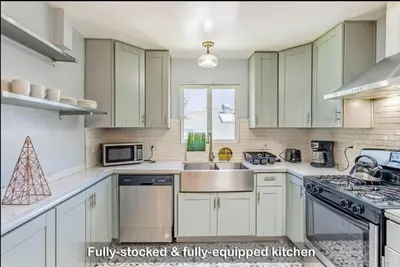 a kitchen with white cabinets and a sink at 4Bedrooms Home Laundry Parking Walk to SDSU in San Diego