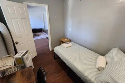 a small room with two beds and a door at 4Bedrooms Home Laundry Parking Walk to SDSU in San Diego