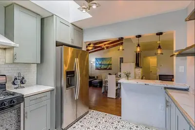 an open kitchen with white cabinets and a kitchen island at 4Bedrooms Home Laundry Parking Walk to SDSU in San Diego