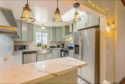 a kitchen with green cabinets and a marble counter top at 4Bedrooms Home Laundry Parking Walk to SDSU in San Diego