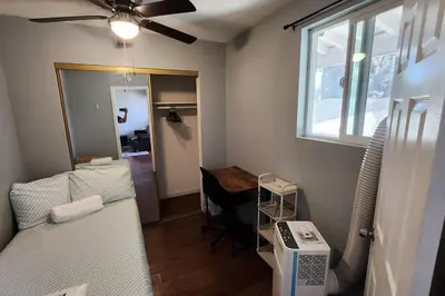 a room with a bed and a table and a window at 4Bedrooms Home Laundry Parking Walk to SDSU in San Diego