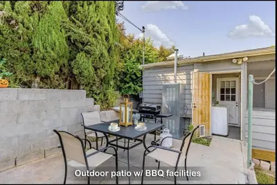 a patio with a table and chairs and a building at 4Bedrooms Home Laundry Parking Walk to SDSU in San Diego