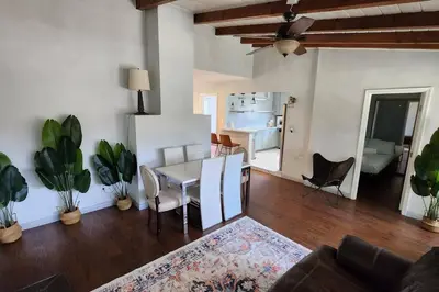 a living room with a table and chairs and a kitchen at 4Bedrooms Home Laundry Parking Walk to SDSU in San Diego