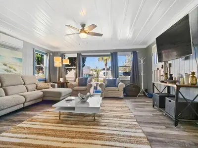a living room with a couch and a table at Comfy Cottage Near the Beach in San Diego